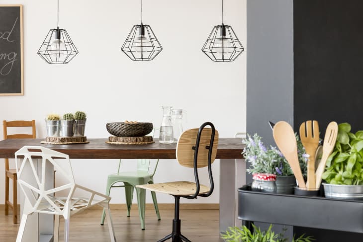 dining room with modern wire-frame pendant lights above the table