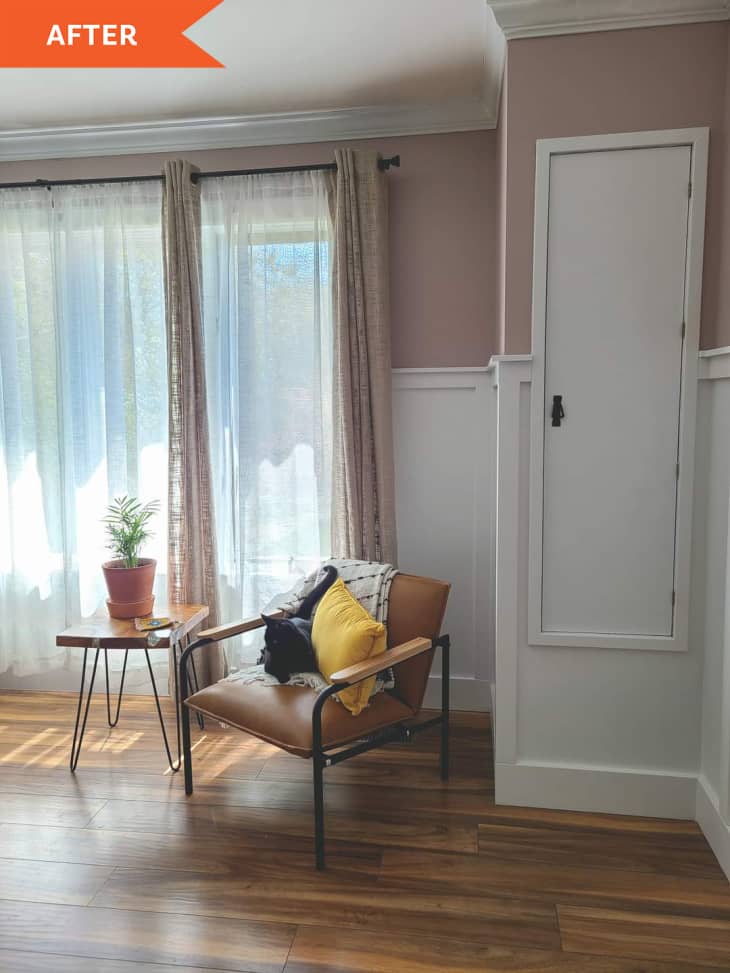 After: Corner of bedroom, featuring pink walls, white wainscoting, and a modern leather armchair