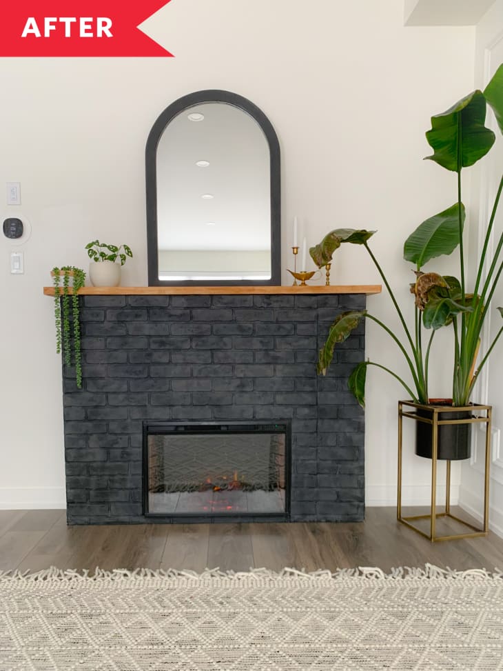 white wall black painted brick fireplace