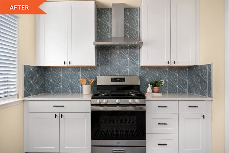 White kitchen cabinets with oven and wallpapered wall
