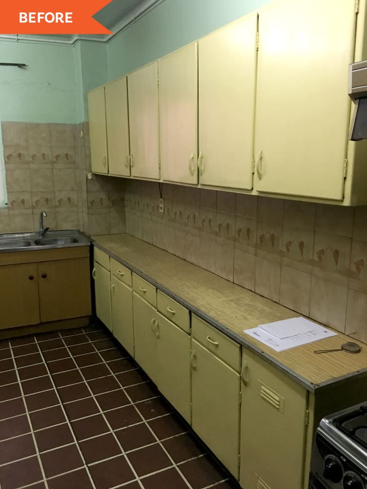 Before: Dated kitchen with yellow cabinets and brown square tiles