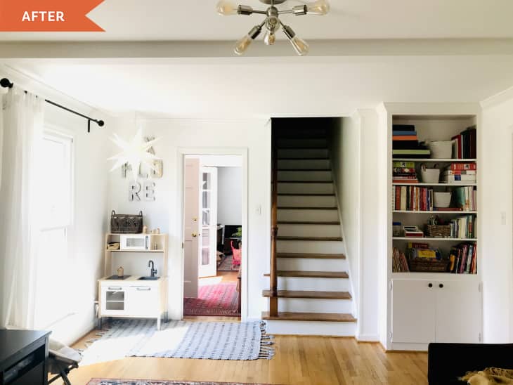 After: View of the bottom of stairs in between a built-in bookshelf and a table