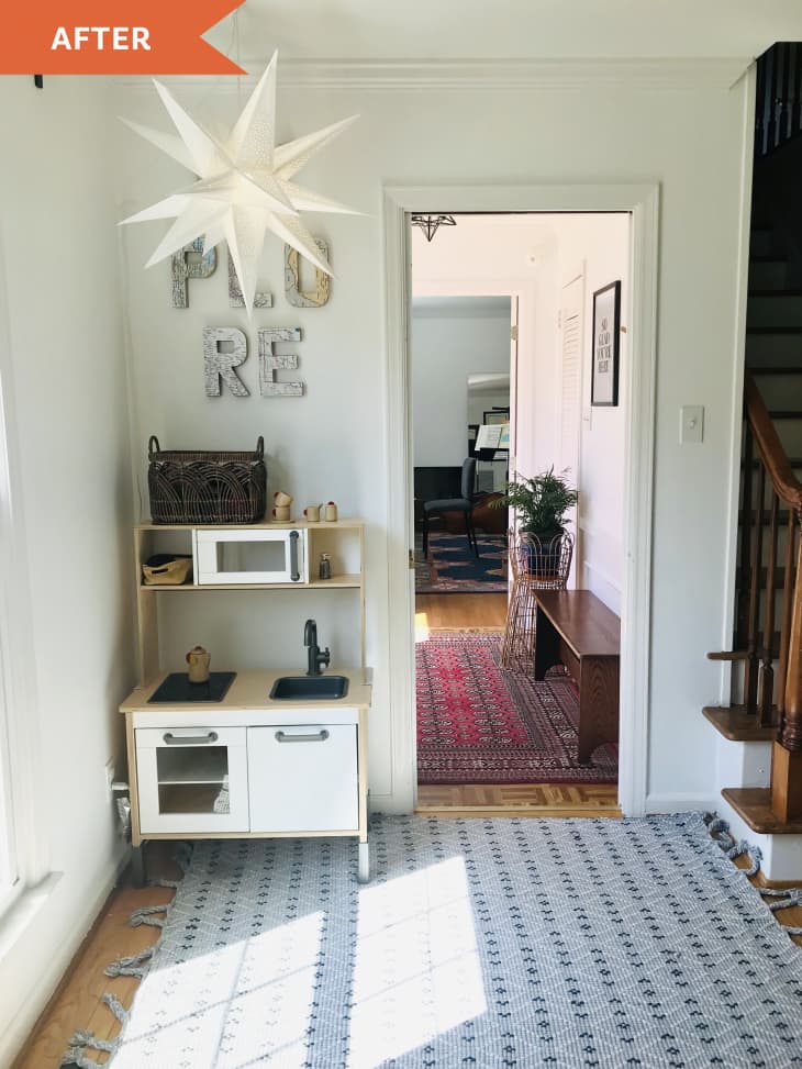 After: corner of room leading to hallway with a kids play kitchen