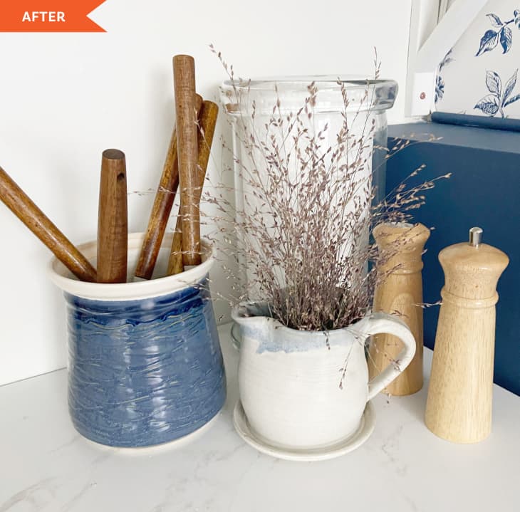 After: white counter with blue jar and white vase