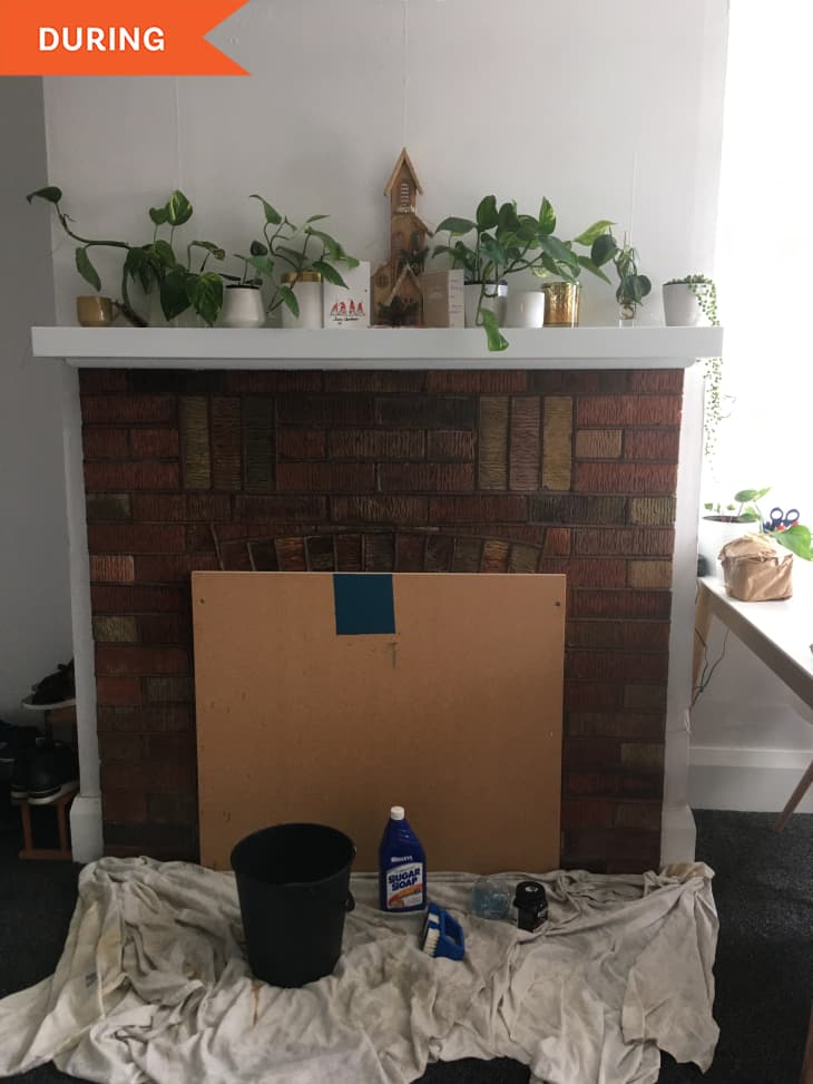During: brick fireplace with cardboard in front