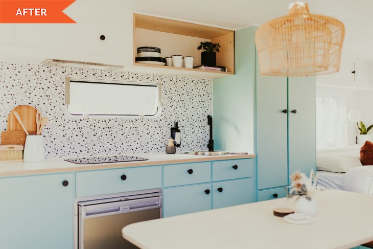 After: Light blue painted kitchen with a small dining table