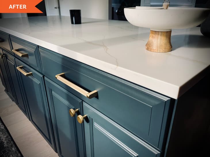 After: dark blue kitchen cabinets with marble counter tops
