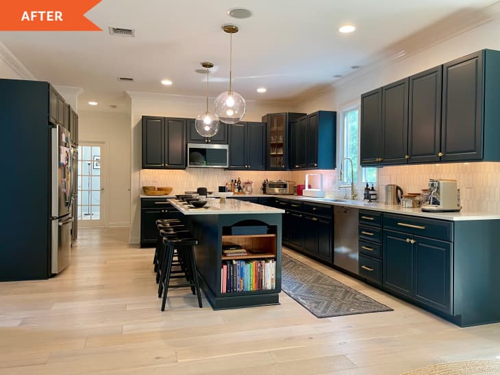 After: full view of the kitchen with dark blue cabinets and an island in the middle