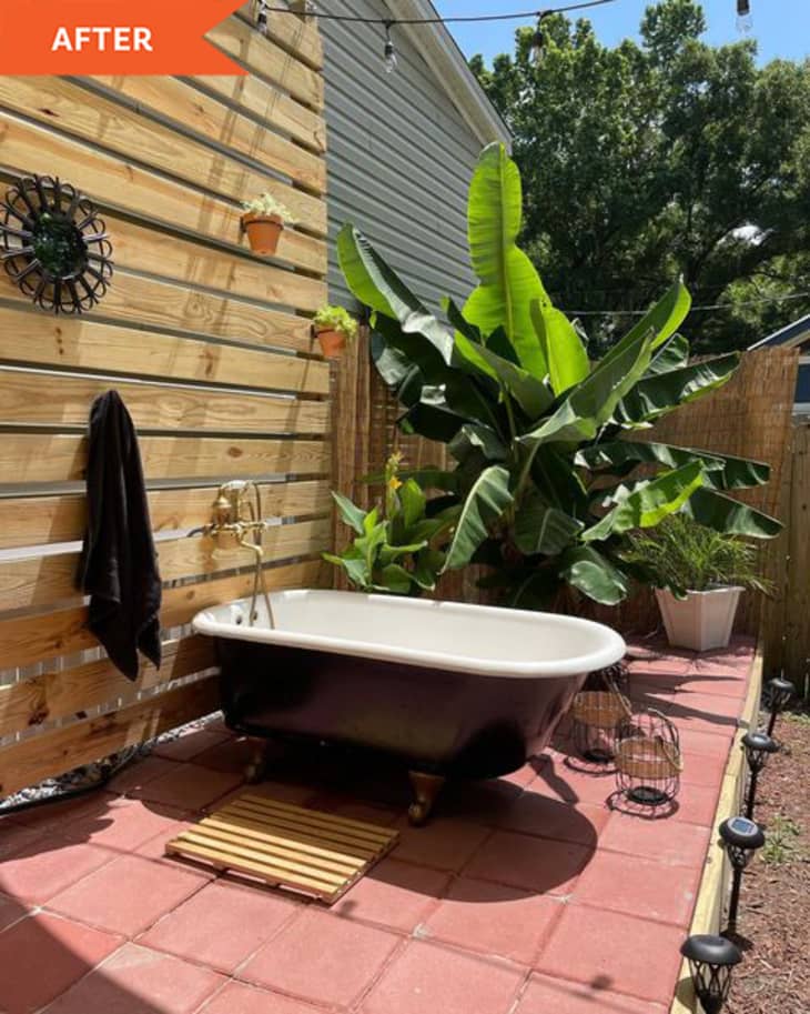 After: outdoor bathtub next to plant