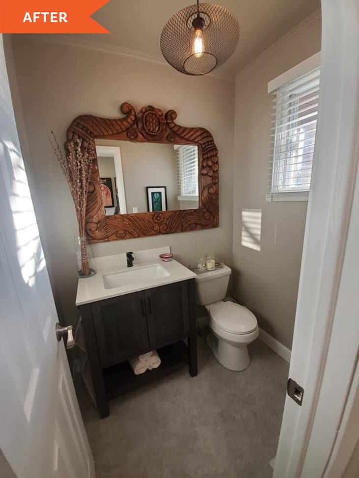 After: bathroom with wooden mirror and hanging light
