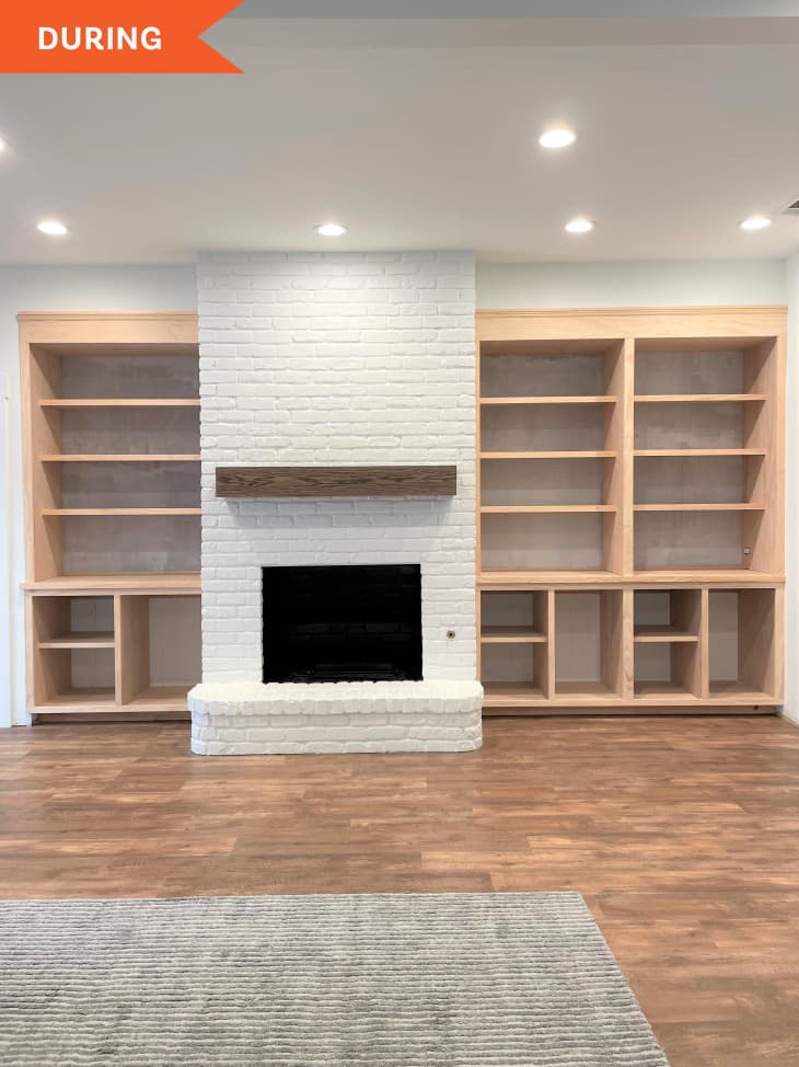 During: White brick fireplace with unpainted wooden shelving on both sides