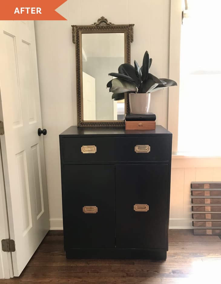 After: Black cabinet with brass pulls and vintage mirror on top