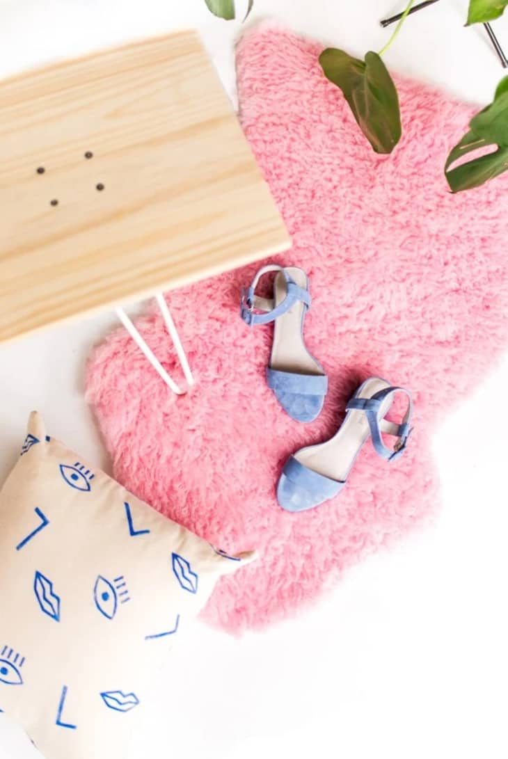 Pink sheepskin rug with blue shoes on top