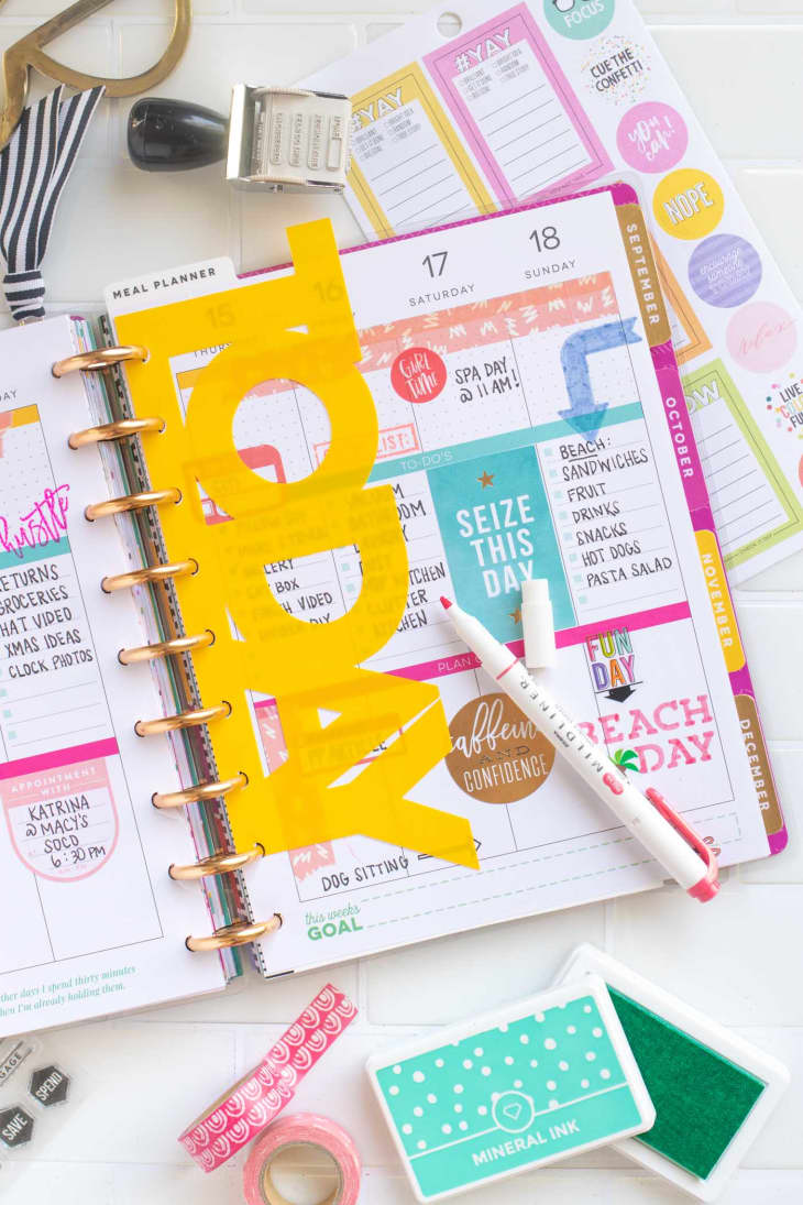 An open yellow and pink planner