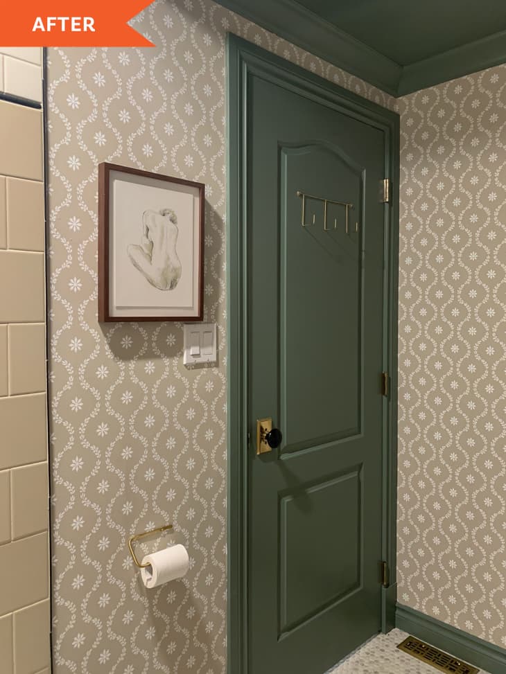 After: green bathroom door next to wallpapered wall