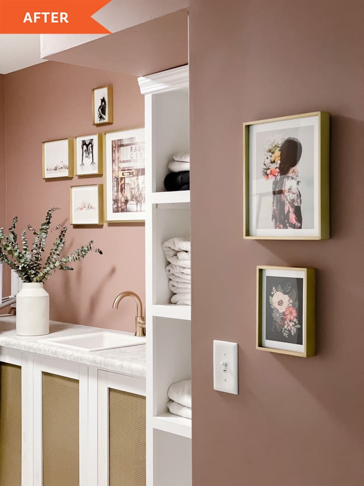 后置:淡粉色的墙壁，带有现代风格的水槽和墙上的艺术品