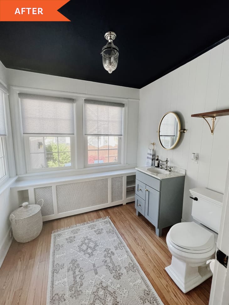 After: a white bathroom with a gray rug and gray sink