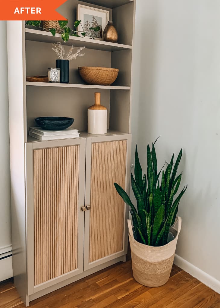 After: a tan bookshelf with a cabinet next to a plant