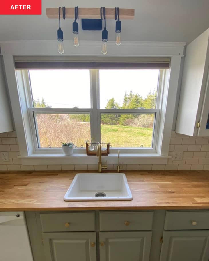 After: a white kitchen sink in front of a large window