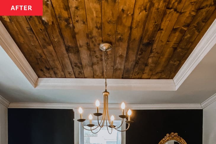 After: a wooden ceiling with a chandelier hanging