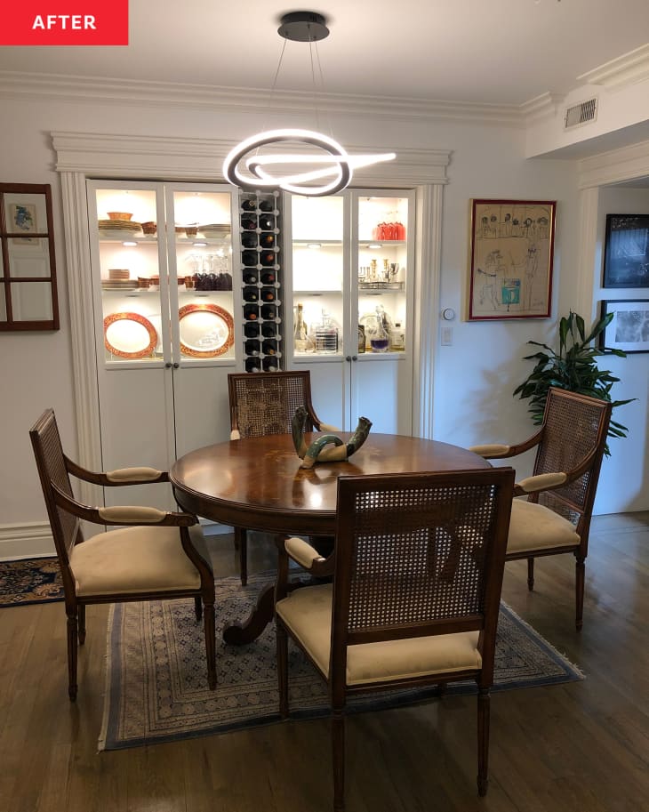 After: a round dining table next to two white built in bookshelves