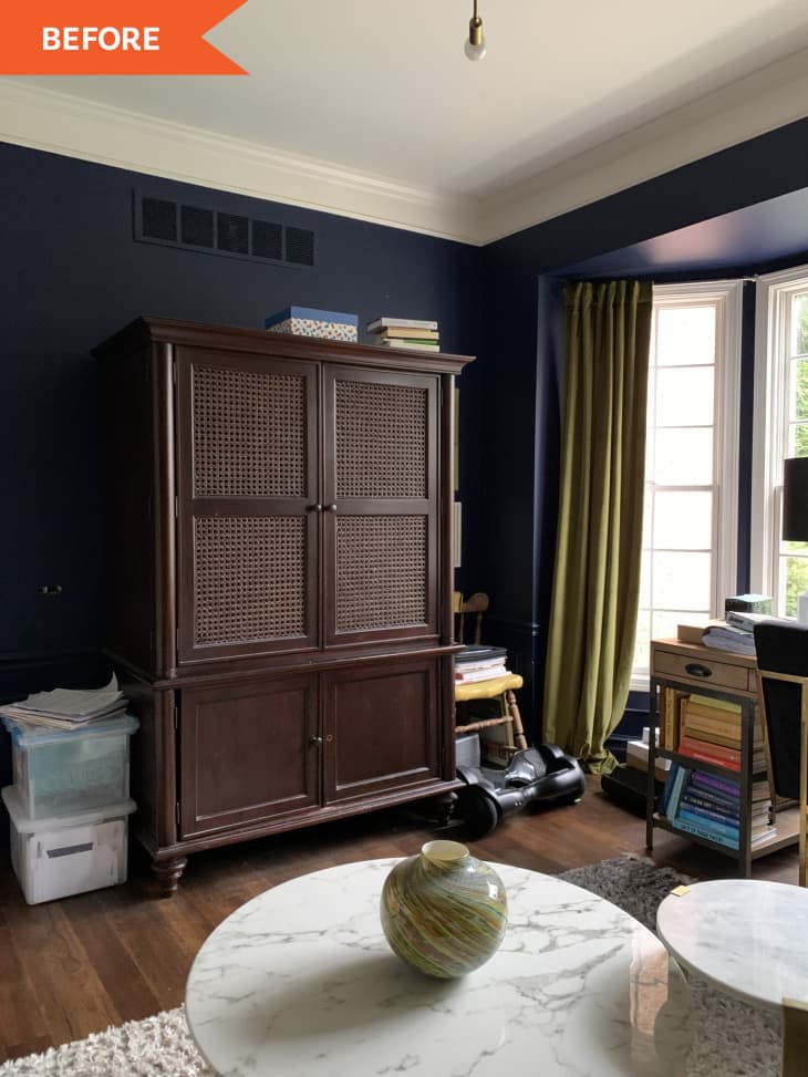 Before: View of office with navy blue walls and large dark wood cabinet.