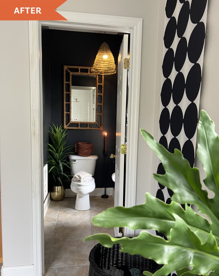 After: View into bathroom, with white toilet against a black painted wall.