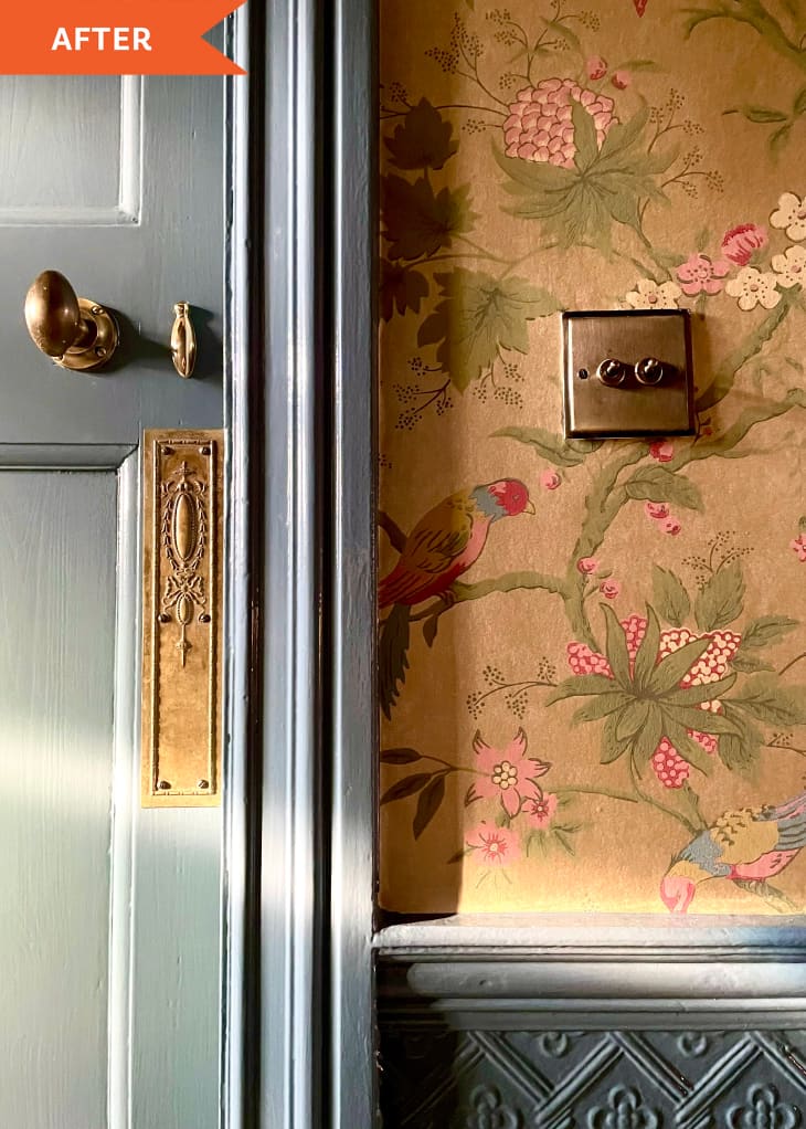After: a light blue door next to golden wallpaper with a pink flower printed on it