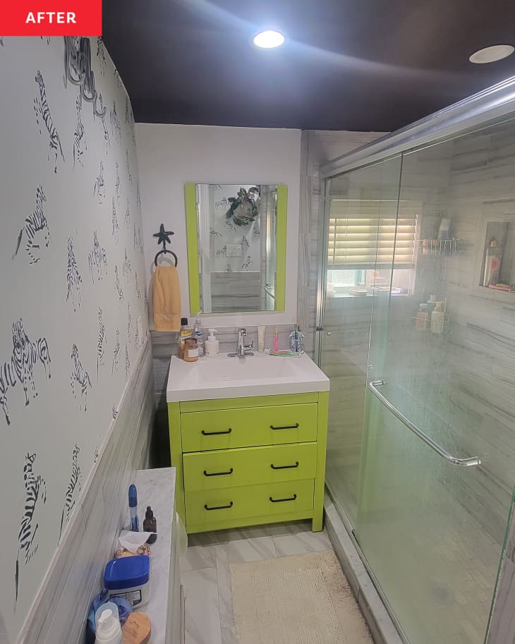After: a lime green bathroom cabinet and drawers surrounded by zebra wallpaper