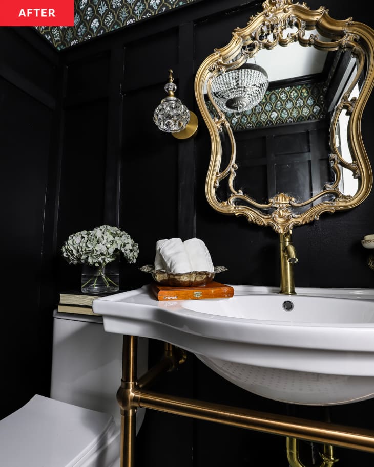 After: a black bathroom with a gold mirror and gold faucet