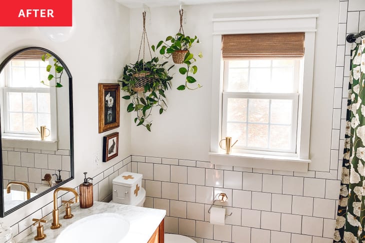 After: a white bathroom with tiles and plants hanging from the ceiling