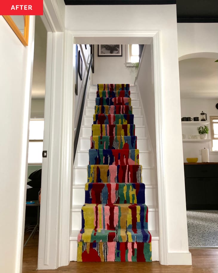 After: the bottom of stairs with multi-colored carpeting