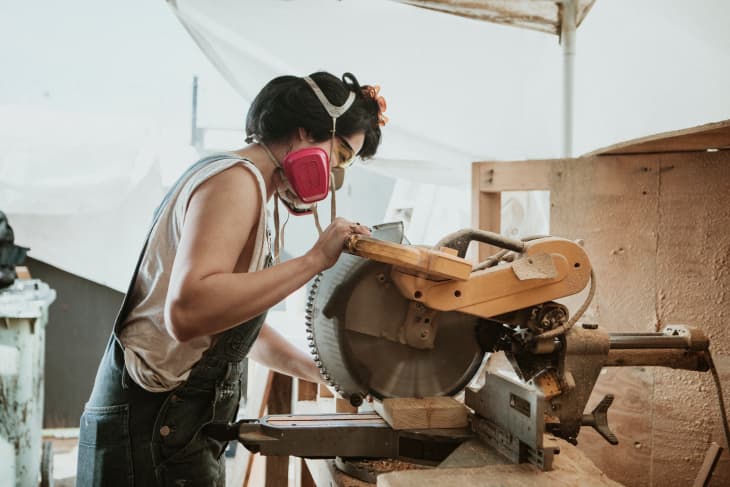 Carpenter using a miter saw to cut wood