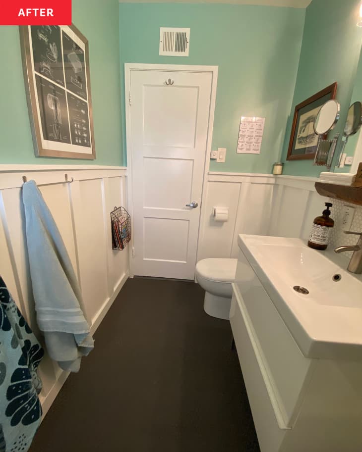 After: a bathroom with blue-green walls on the top and white paneling on the bottom of the wall