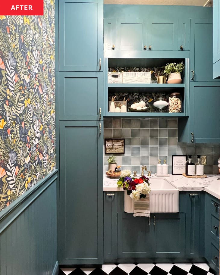 After: a floral wallpaper accent wall next to blue-green cabinets and a white sink