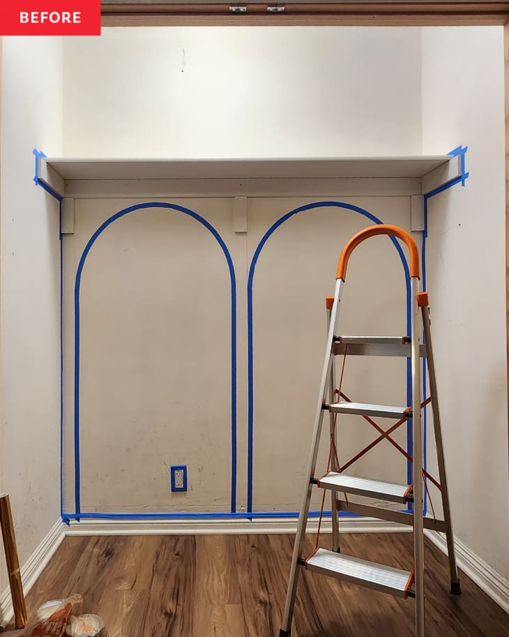 Before: a white wall with painters tape creating arches on the wall