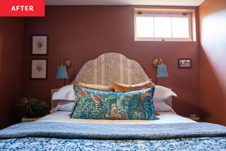 After: an orange-brown bedroom with a large bed with blue pillows and blankets