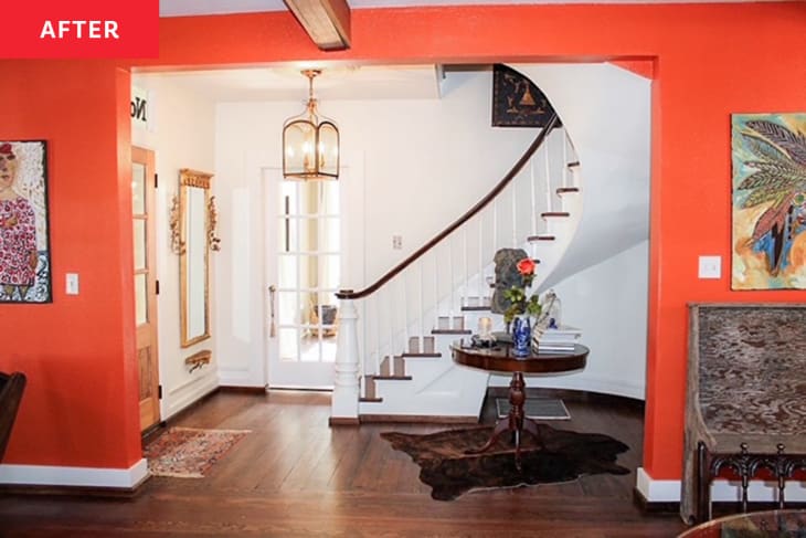 After: an orange wall leading to a white entryway with a grand staircase