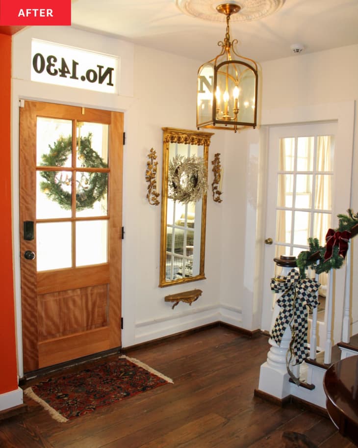 After: an entryway with a wooden door next to a white staircase