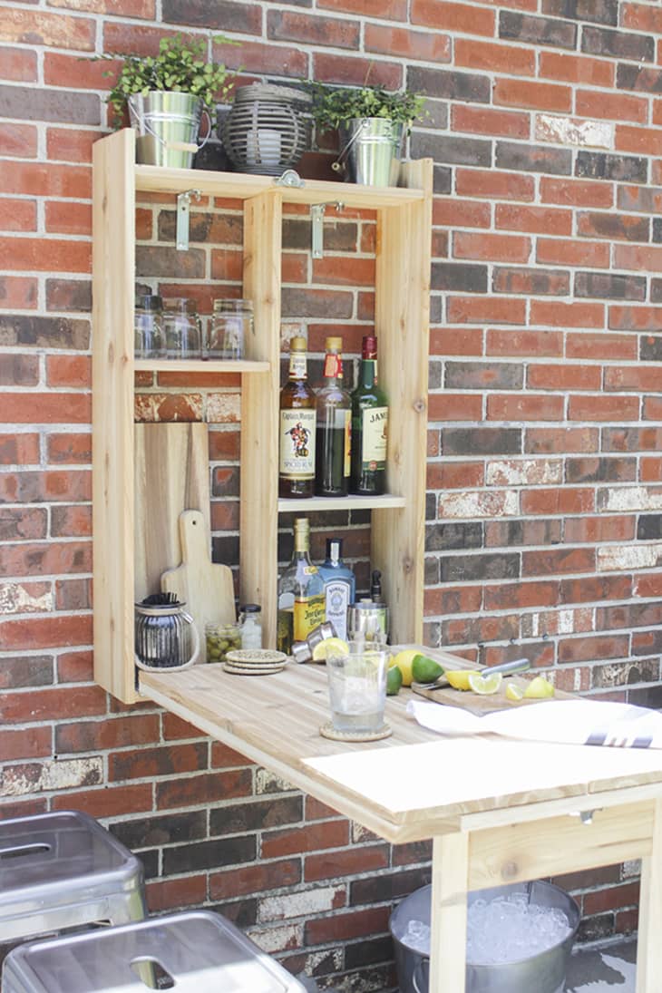 Outdoor wall-mount fold-down bar with storage