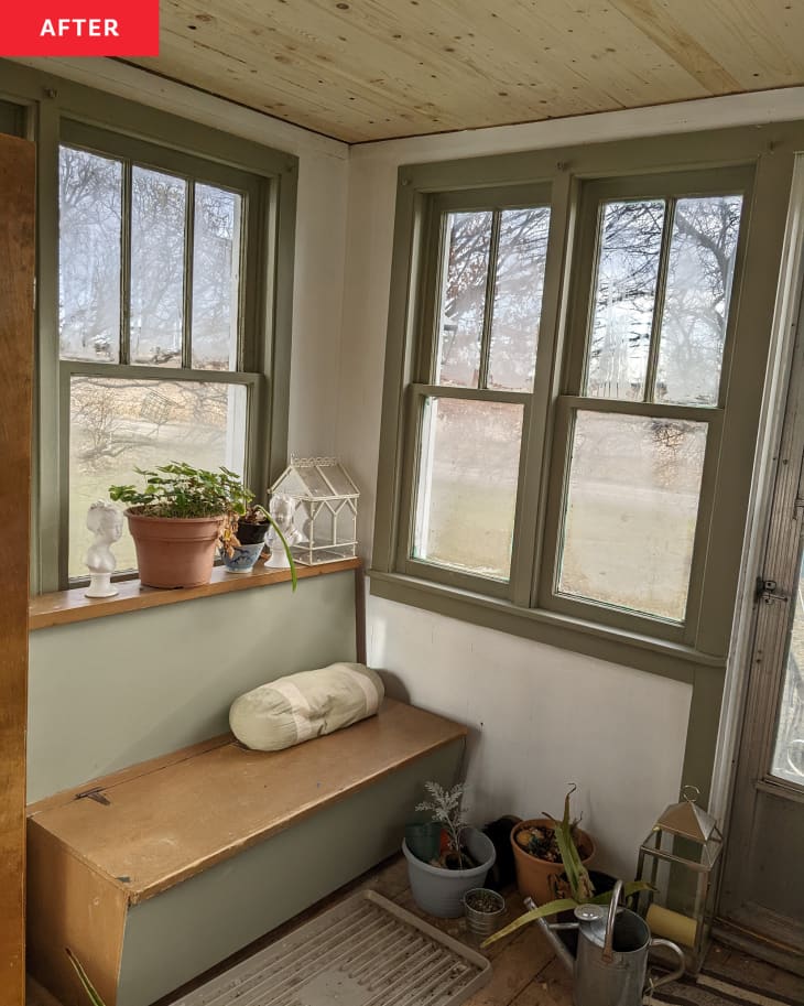 After: the corner of a white and green mudroom with a small bench below the windows