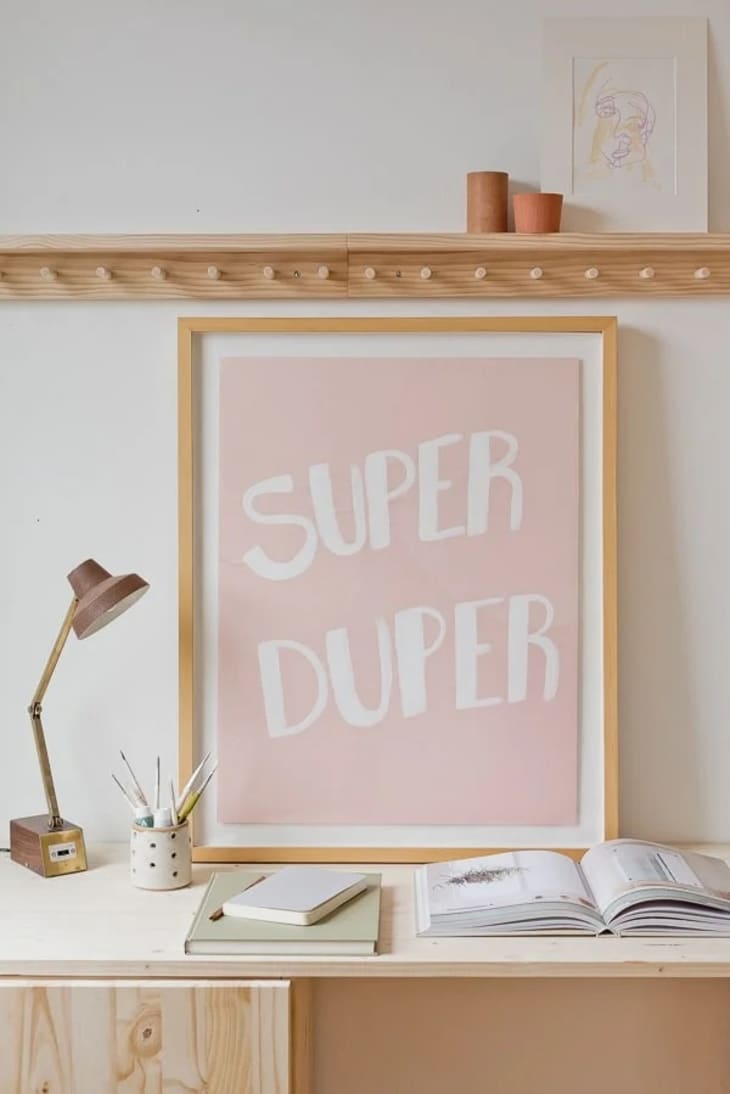 A pink piece of art that reads "Super Duper"