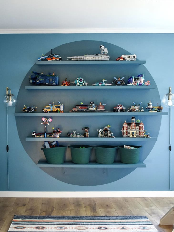 A blue wall with a round shelf display