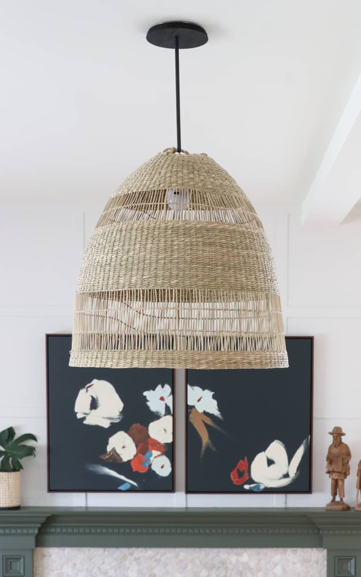 A woven pendant light hanging from a white ceiling