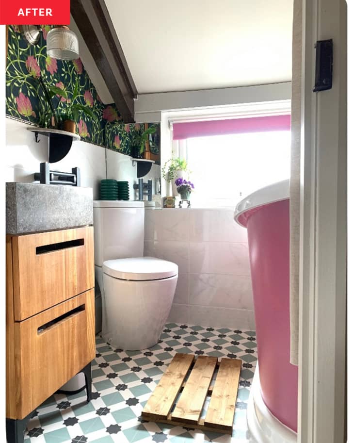 After: a bathroom with floral wallpaper and a pink tub