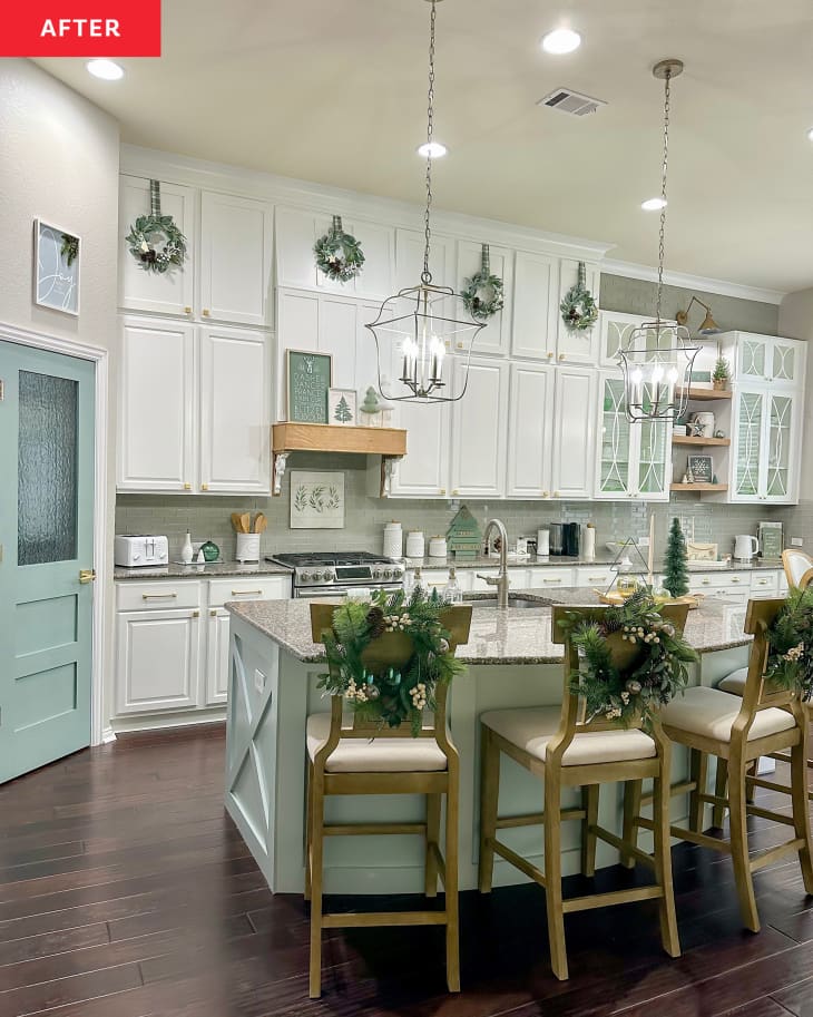 After: white kitchen cabinets with stools at a blue island