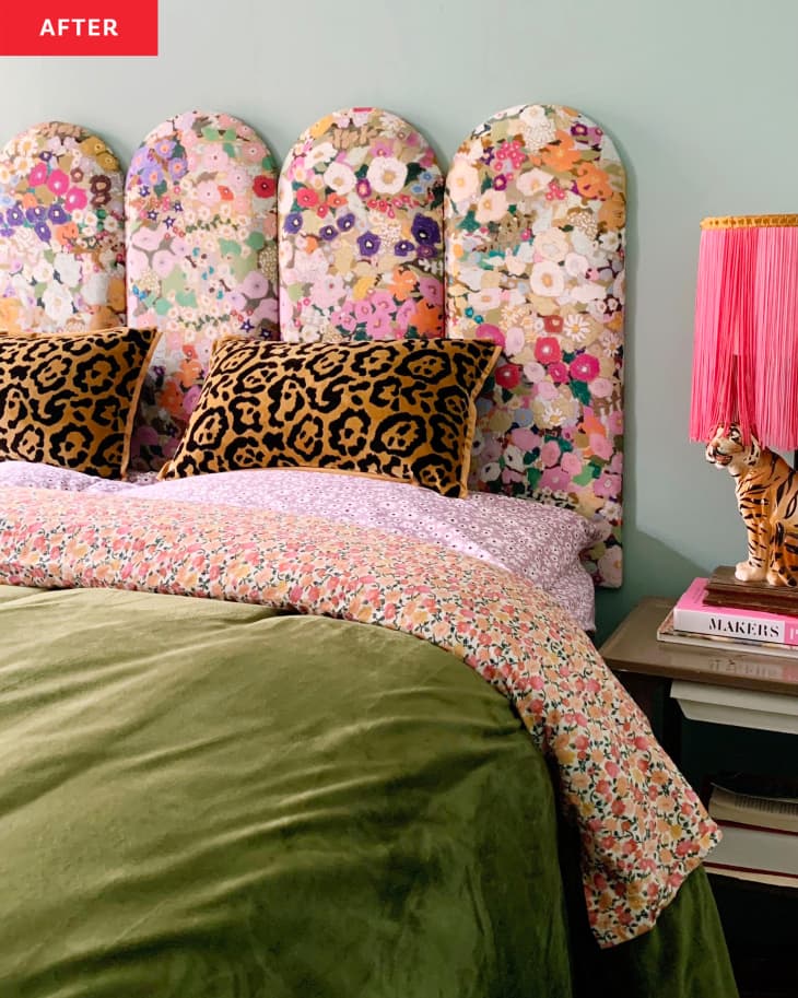 Headboard crafted from a deconstructed IKEA BILLY bookcase. Planks of wood have been covered with floral fabric, creating quilted effect. Leopard spot pillows, floral sheets, green velvet duvet cover. Tiger lamp with pink fringe on bedside table