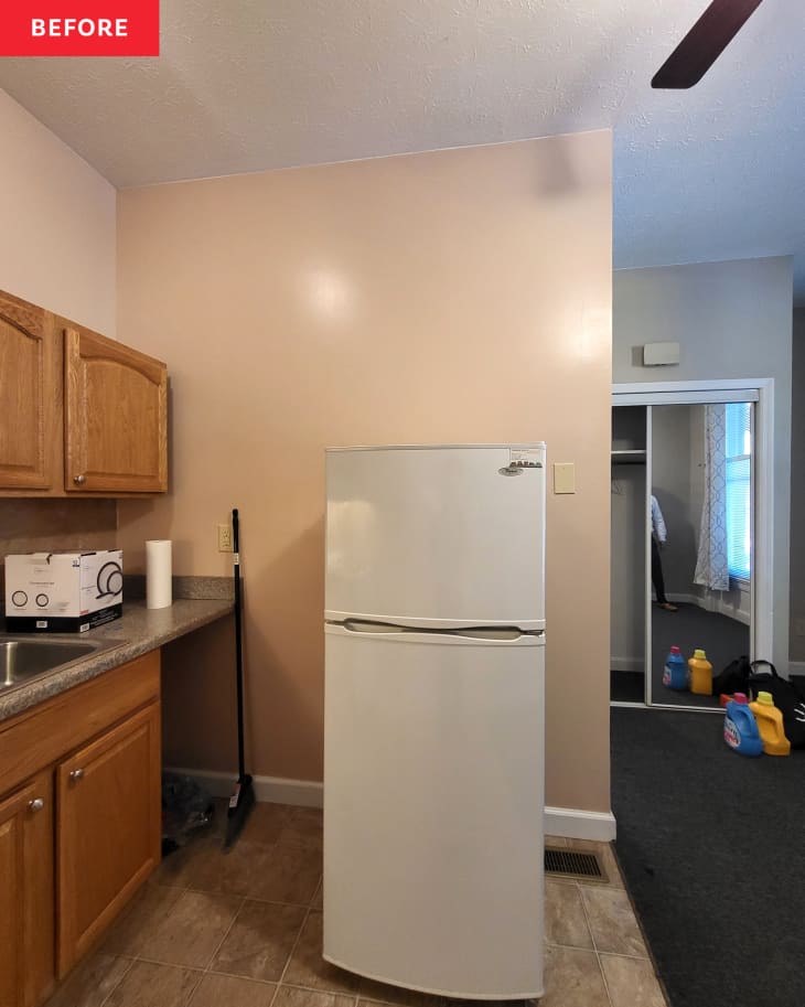 Refrigerator in kitchen before renovation.