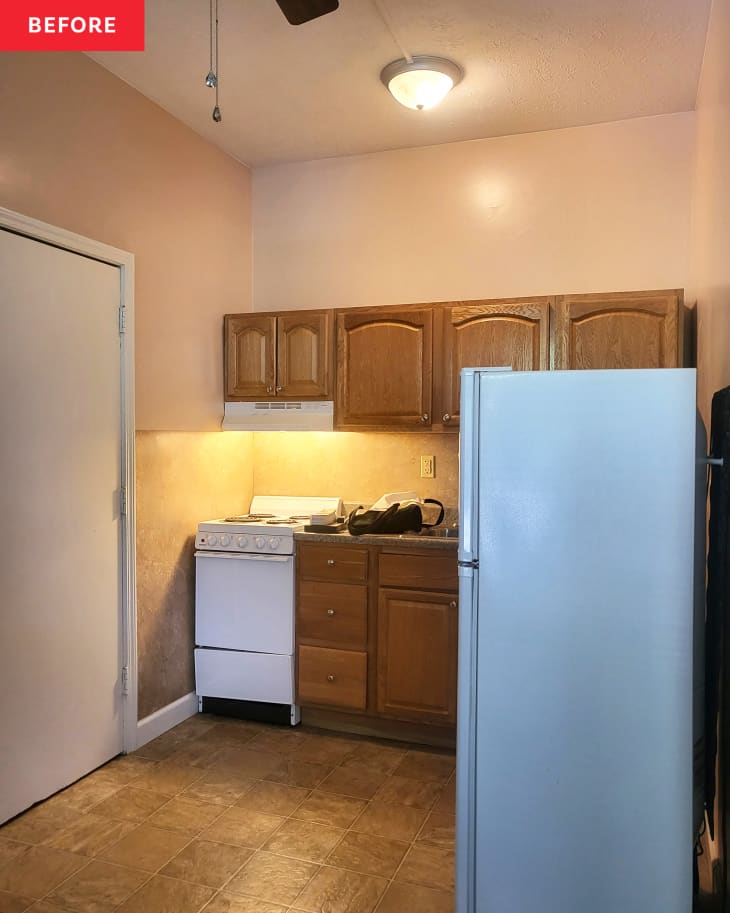 Kitchen with wooden cabinets before renovation.