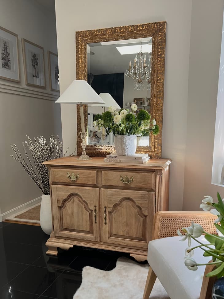 Bleached wood buffet table with a mirror hanging above it.